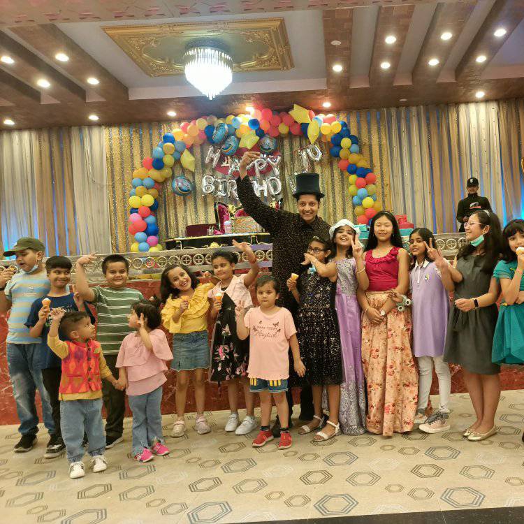 Koirala Sarkar with children after a birthday magic show