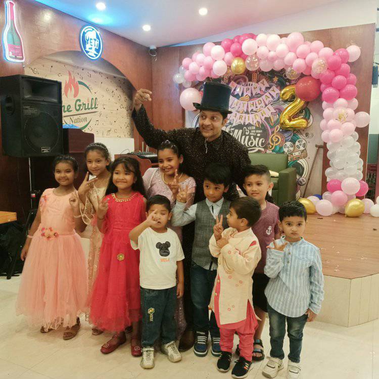 Koirala Sarkar with children at a birthday party